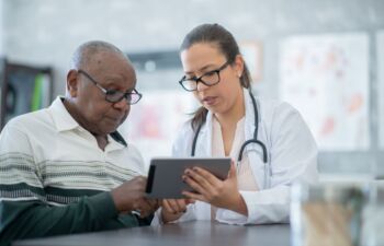 Getty Images-1293814791-doctor-and-patient-resize